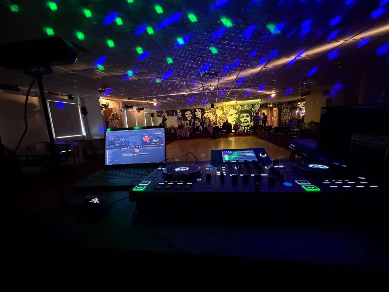 Dan’s DJ decks with event lighting across the venue